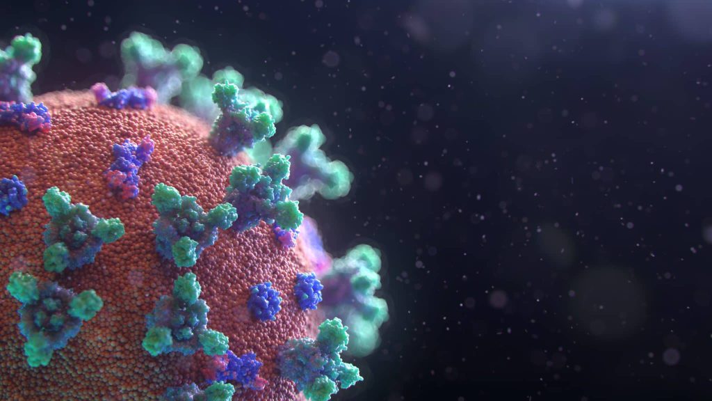 Close-up of a virus particle with red surface and blue-green spike proteins against a dark background