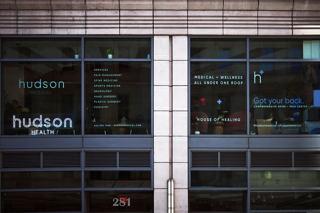 Storefront with Hudson Medical branding on glass windows across two sections.